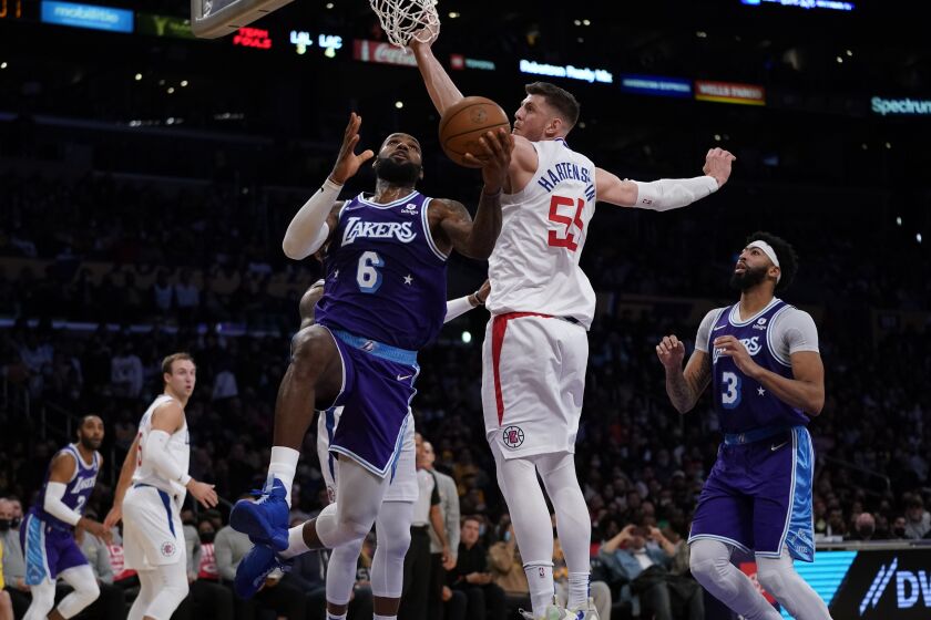 Los Angeles Lakers forward LeBron James (6) shoots against Los Angeles Clippers center Isaiah Hartenstein (55) during the second half of an NBA basketball game in Los Angeles, Friday, Dec. 3, 2021. (AP Photo/Ashley Landis)