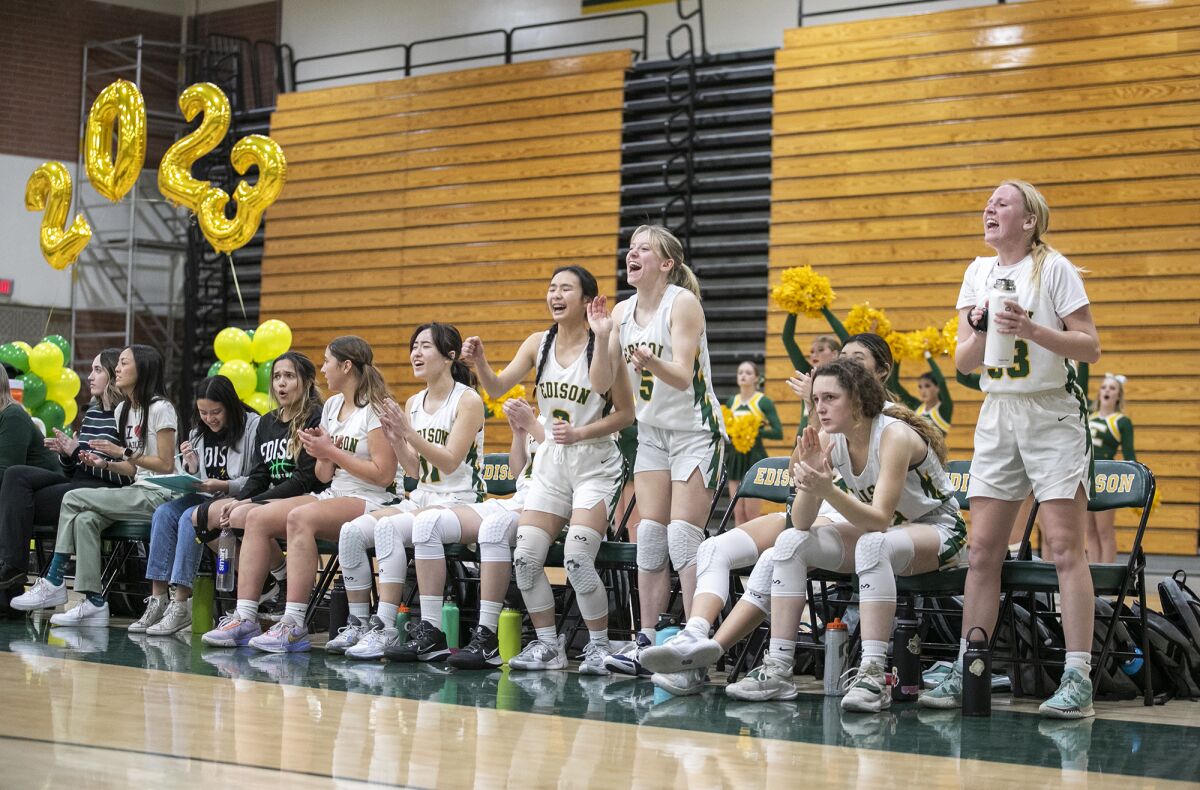Edison's bench celebrates during a Wave League girls' basketball game against Huntington Beach on Thursday.