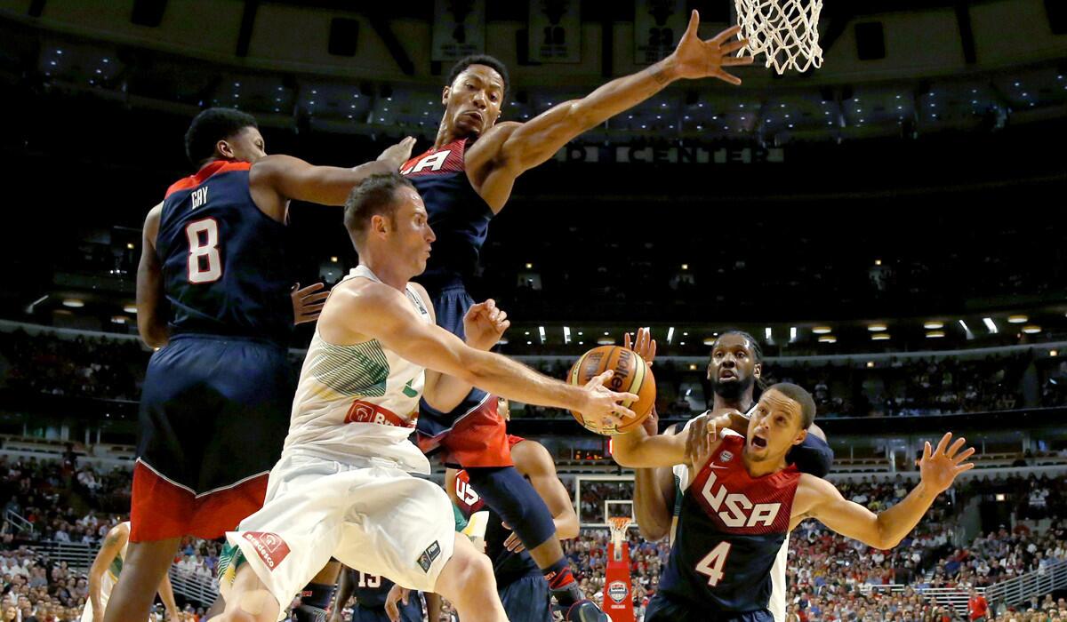 Brazil's Marcelo Huertas tries to pass the ball past U.S. defenders Rudy Gay, Derrick Rose and Stephen Curry during an Aug. 16, 2014, exhibition game in Chicago.