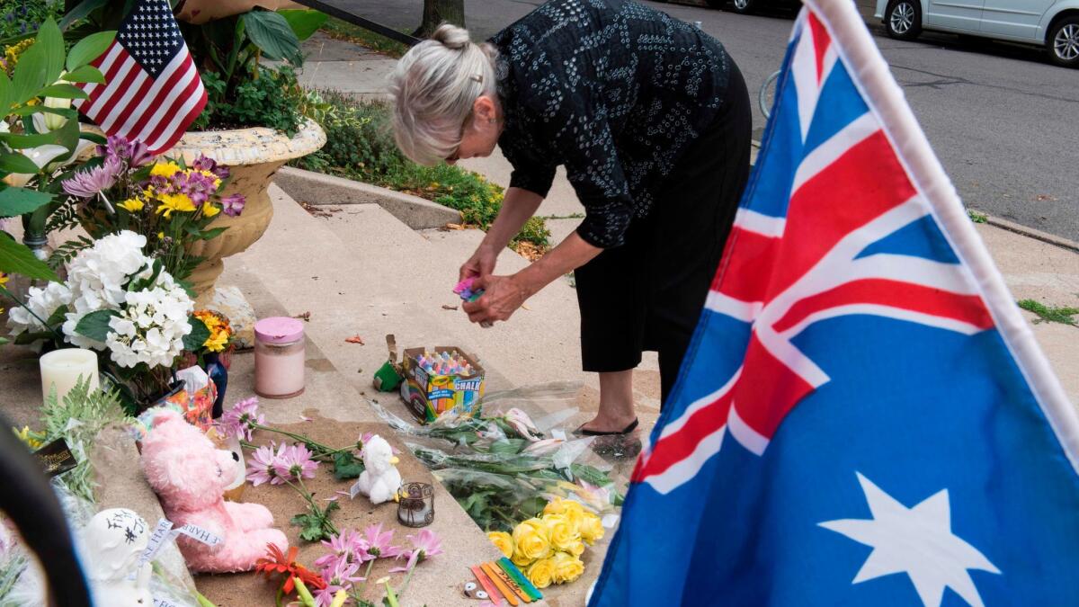 Nancy Coune, administrator of the Lake Harriet Spiritual Community centre, places flowers and signs memorializing Justine Damond at a makeshift memorial on July 18, 2017 in Minneapolis, Minnesota.