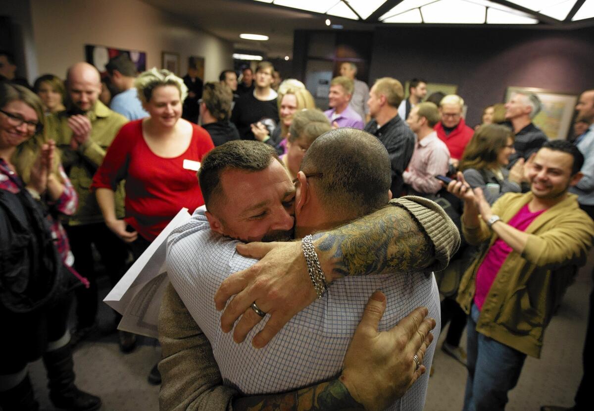 Chris Serrano, left, and Clifton Webb embrace after their wedding in the Salt Lake County clerk's office earlier this month. In the week after the Dec. 20 ruling allowing gay marriage in Utah, gay and lesbian applicants made up nearly 75% of the state’s 1,225 marriage licenses issued.