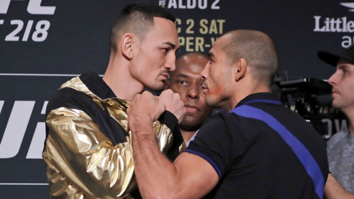 Max Holloway, left, and Jose Aldo get in each other's face on Nov. 30 in Detroit during media day for UFC 218.