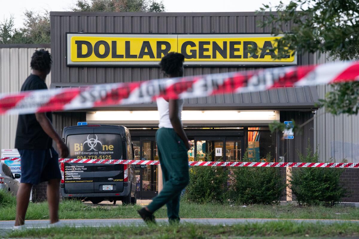 A police barricade is set up outside a Dollar General.