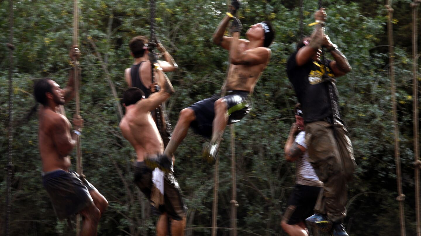 Participants take part in a rope climb challenge during the Spartan Race at Calamigos Ranch in Malibu on Dec. 7, 2014.