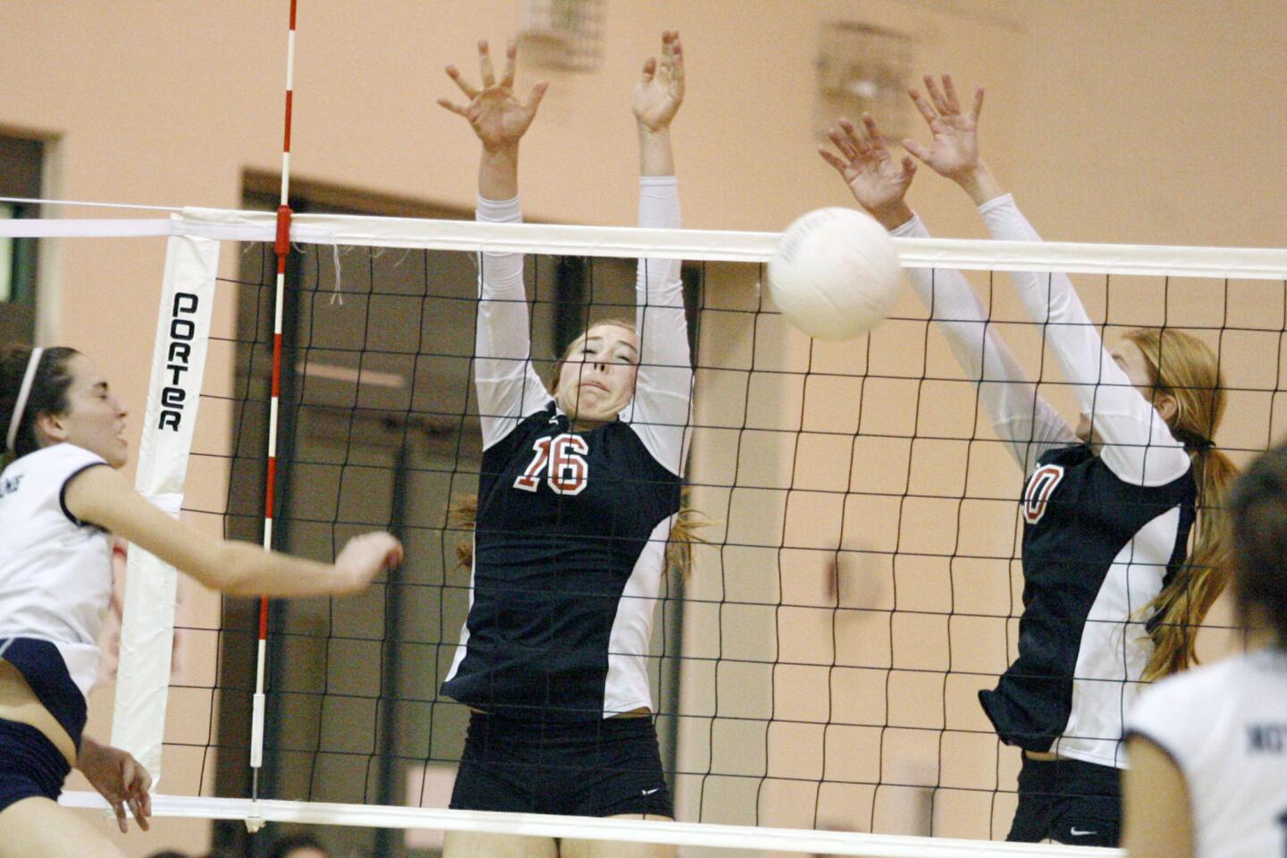 FSHA's Sophia Coffey, center, and Allison Clapp block a spike during a game against Notre Dame at Flintridge Sacred Heart Academy in La Canada on Thursday, October 25, 2012.