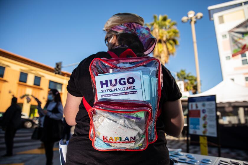 Los Angeles, CA - February 24: A volunteer's backpack is full of campaign material for Hugo Soto-Martinez, candidate for L.A. City Council challenging incumbent Councilman Mitch O'Farrell in Council District 13, at the East Hollywood neighborhood Farmer's Market in Los Angeles, CA, Thursday, Feb. 24, 2022. (Jay L. Clendenin / Los Angeles Times)
