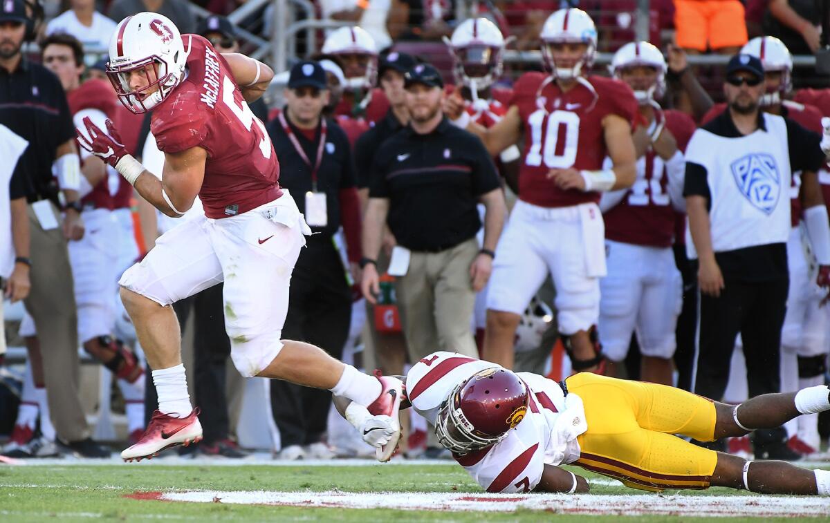 Stanford running back Christian McCaffrey breaks the tackle of USC defensive back Marvell Tell III for a big gain in the second quarter Saturday at Palo Alto.