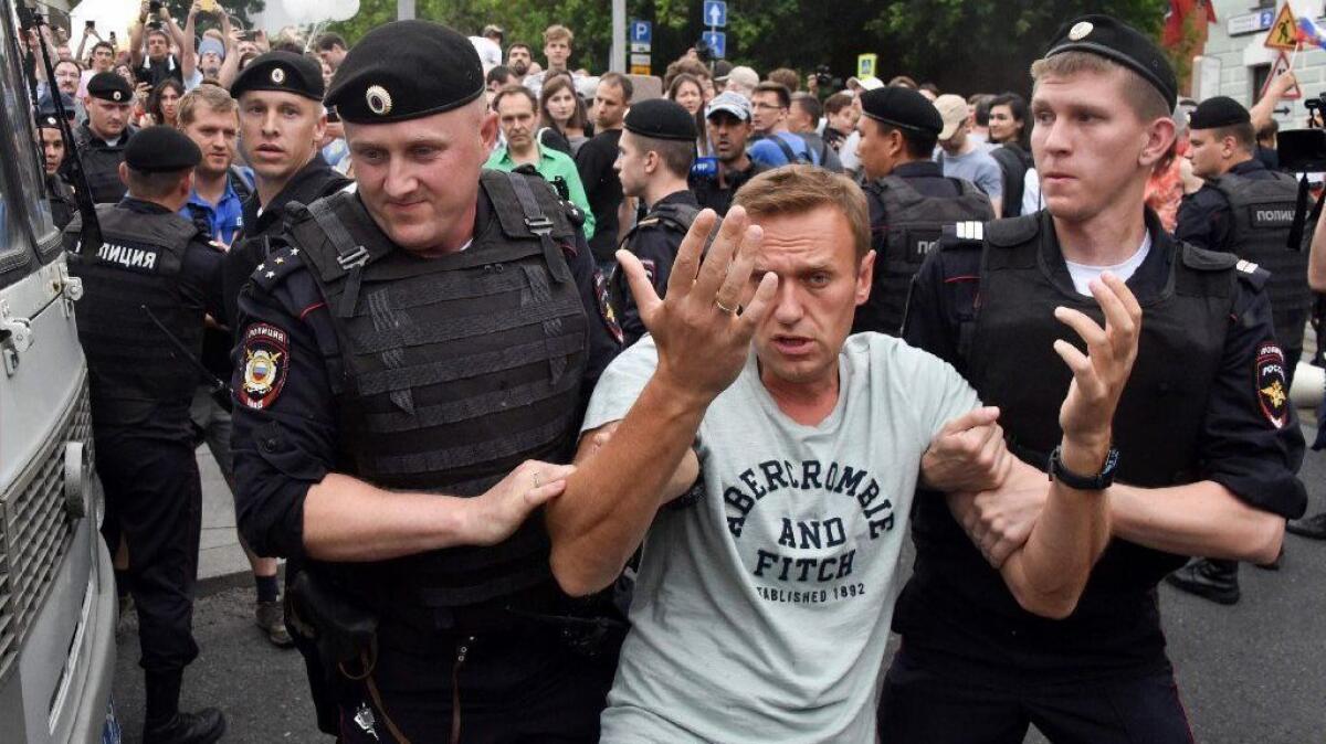 Russian opposition leader Alexei Navalny is detained by police during a march in central Moscow on June 12, 2019.