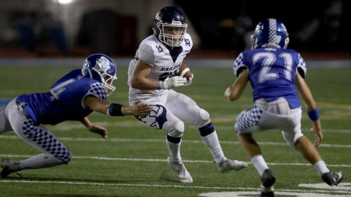 Newport Harbor High running back Justin McCoy (33), seen running the ball at San Marino on Sept. 21, will look to extend the Sailors' unbeaten streak to four games on Friday.