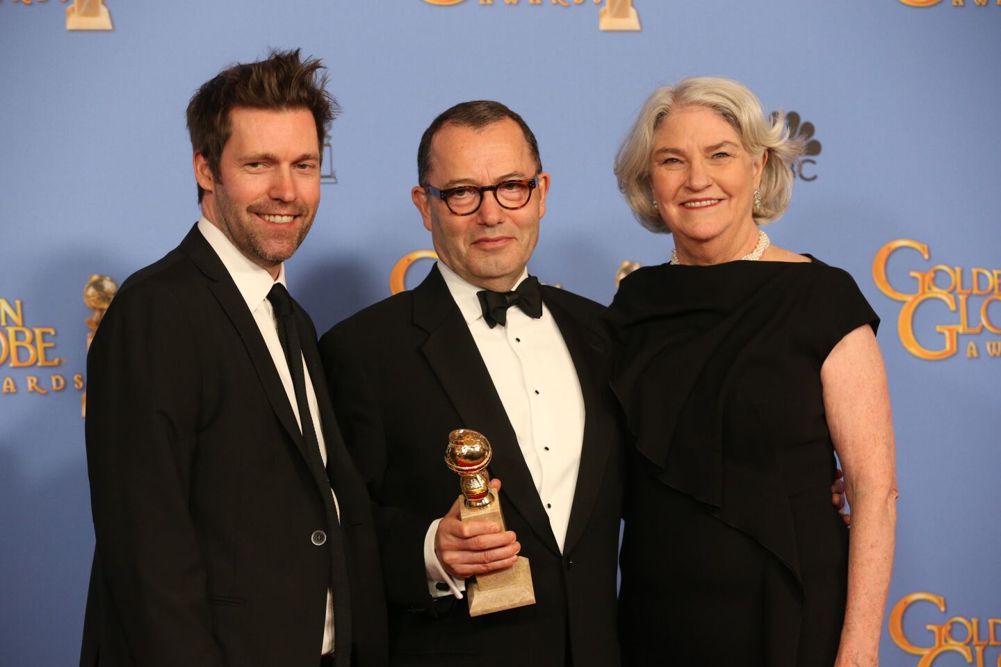 Producers Mark Pybus, left, Colin Callender and Rebecca Eaton, winners of Miniseries or Television Film for "Wolf Hall," pose in the press room at the 73rd Annual Golden Globe Awards show at the Beverly Hilton Hotel on Jan. 10, 2016.