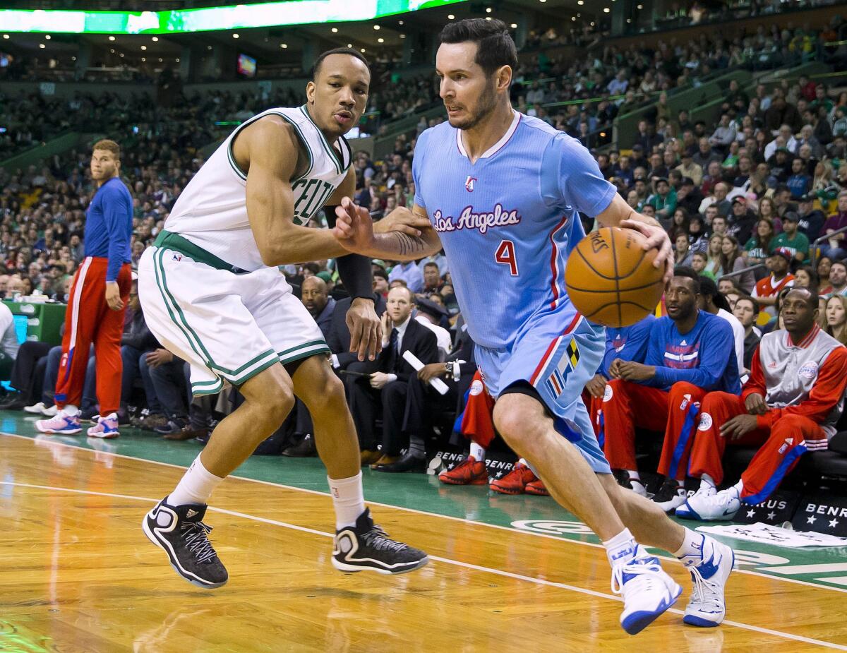 Clippers guard J.J. Redick drives the baseline against Celtics guard Avery Bradley in the first half.