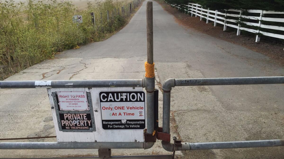 The entrance to Martins Beach is locked by a security gate.