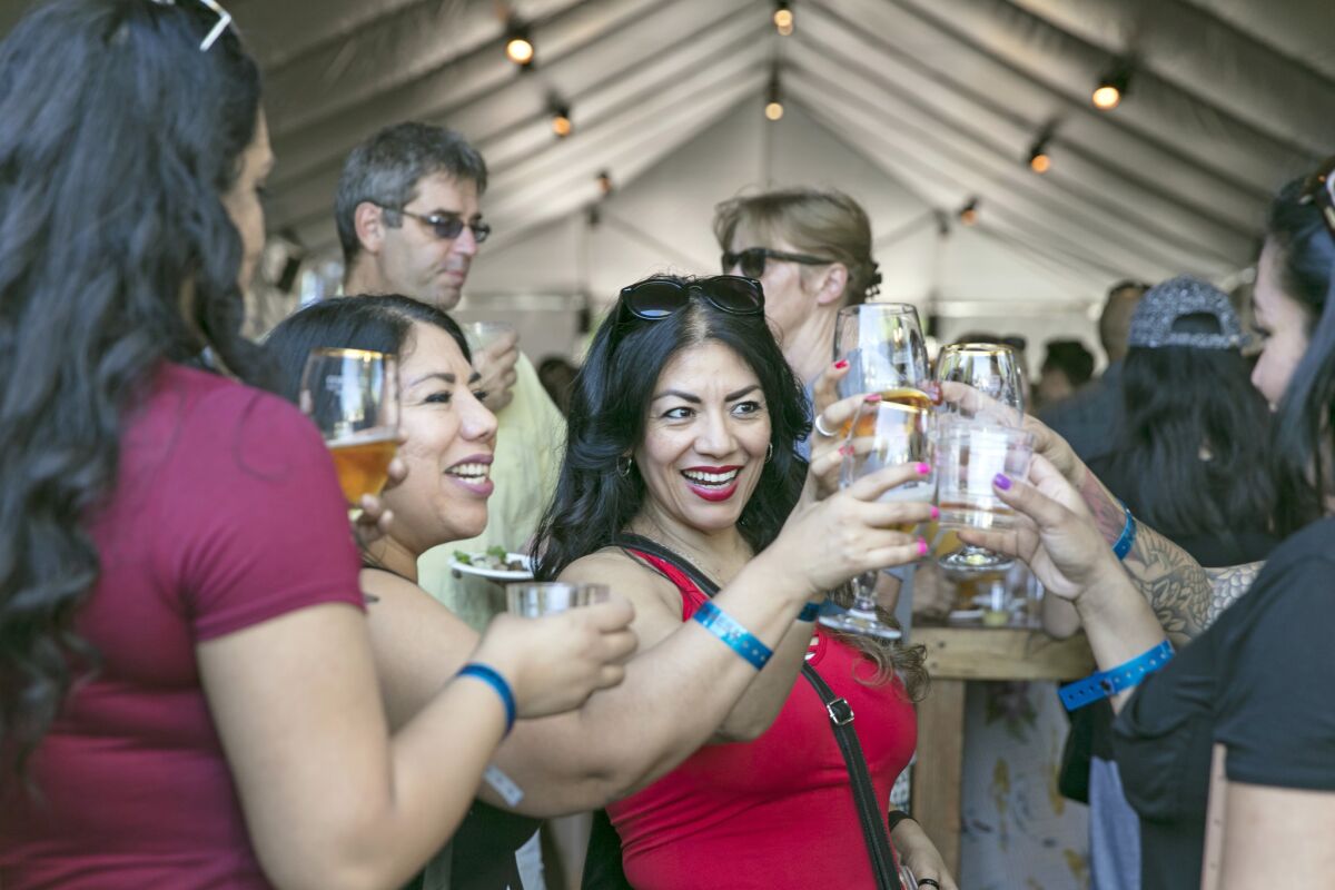 Bertha Andrade, left, her sister Ana Andrade and their friends enjoy drinks during the last day of the L.A. Times' The Taste OC.