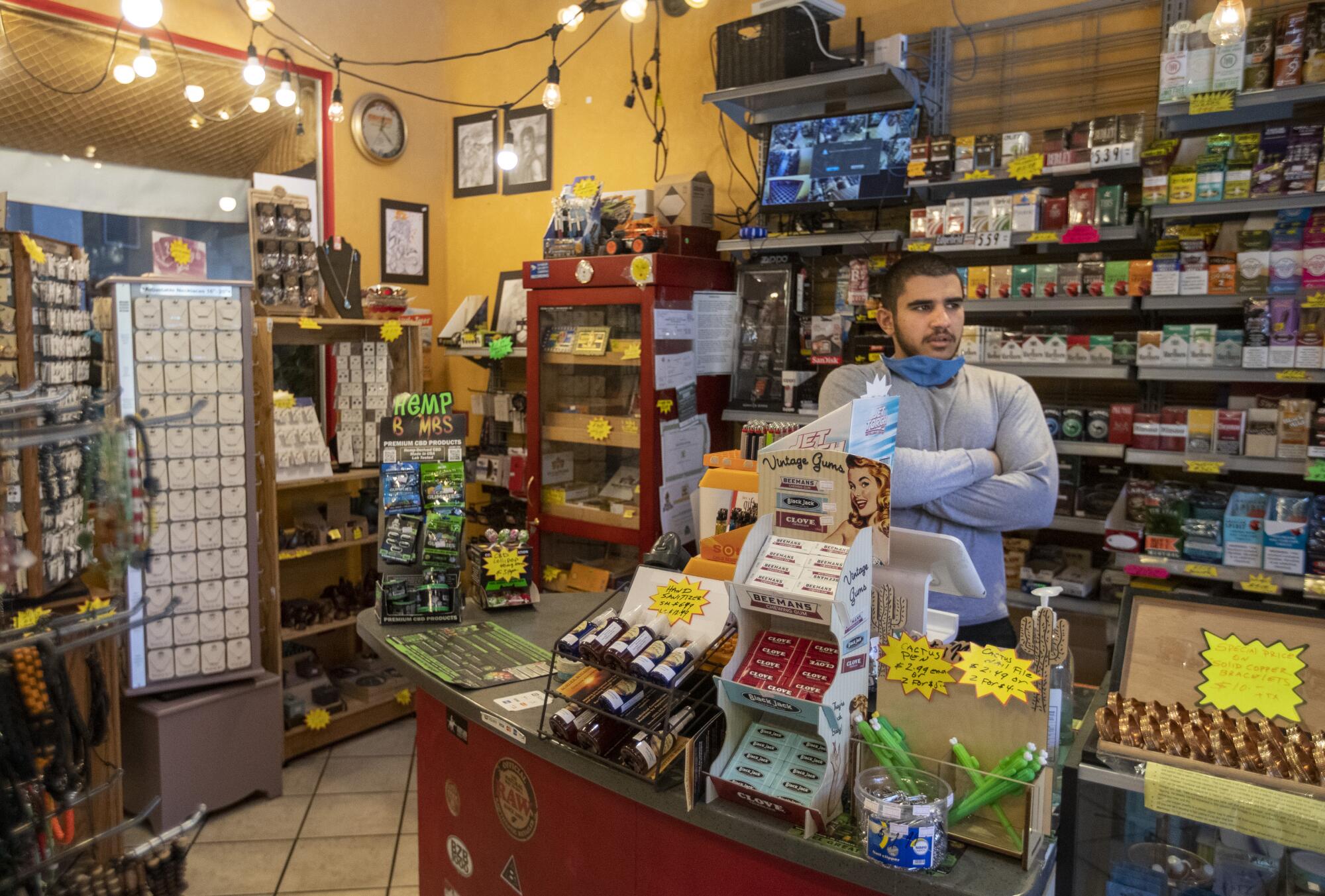 Hassan Sowid waits for customers at Mel's Bisbee Bodega, which is owned by his uncle.