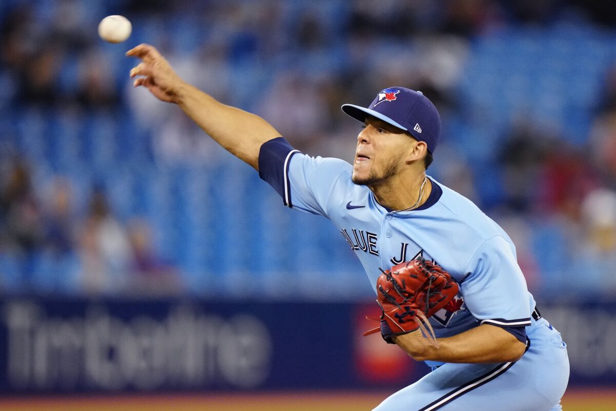 FILE - Toronto Blue Jays starting pitcher Jose Berrios throws against the New York Yankees during the first inning of baseball game in Toronto on Wednesday, Sept. 29, 2021. The Toronto Blue Jays have signed pitcher José Berríos to a seven-year $131 million deal pending a physical, a person familiar with the trade told The Associated Press on Tuesday, Nov. 16, 2021. (Frank Gunn/The Canadian Press via AP, File)