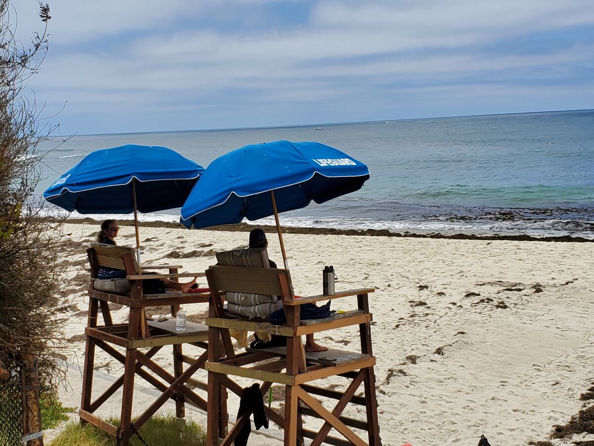 Lifeguards watch over a largely empty Marine Street Beach in La Jolla last week.