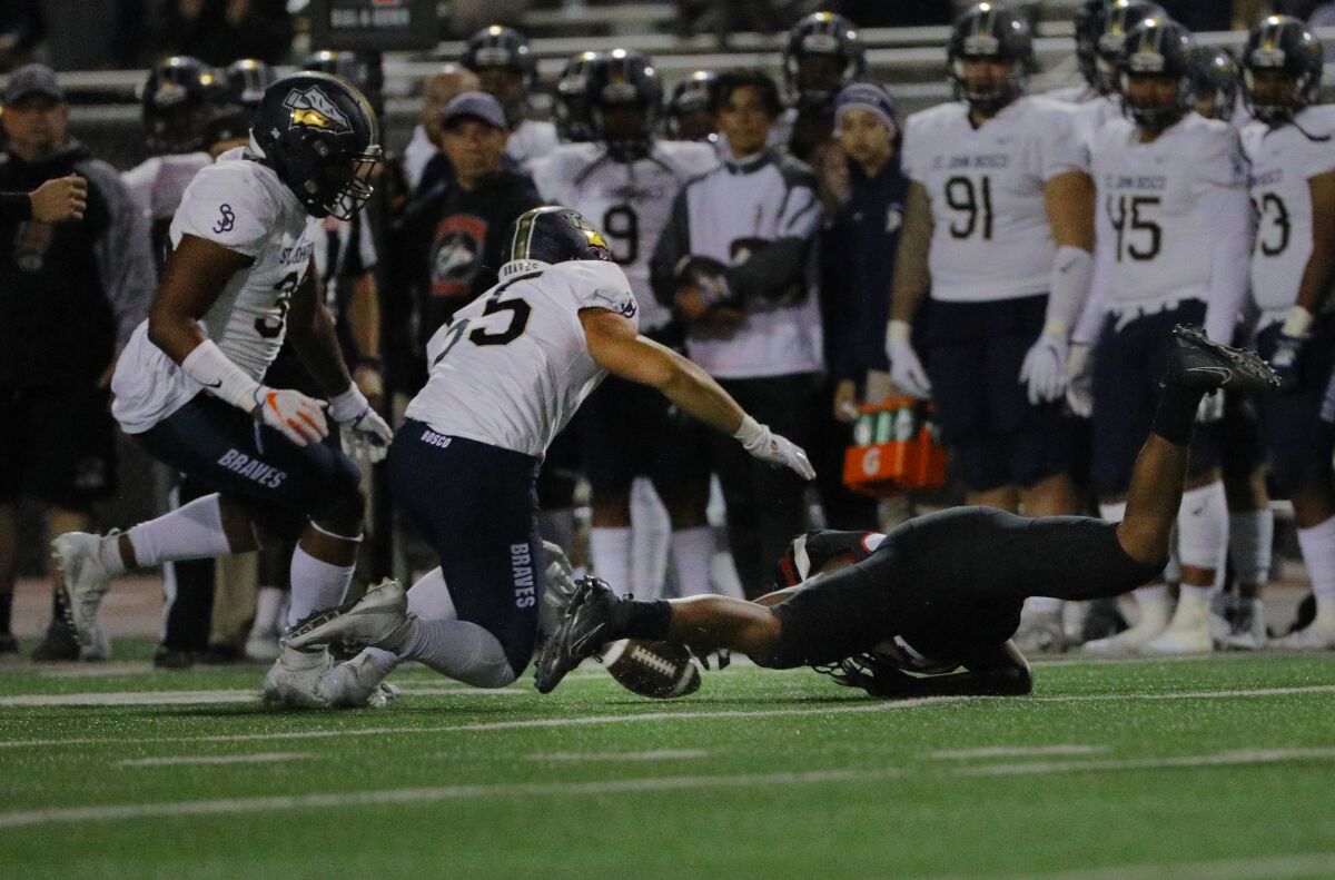 Corona Centennial running back Nicholas Floyd drops the ball on a pitch-out against St. John Bosco.
