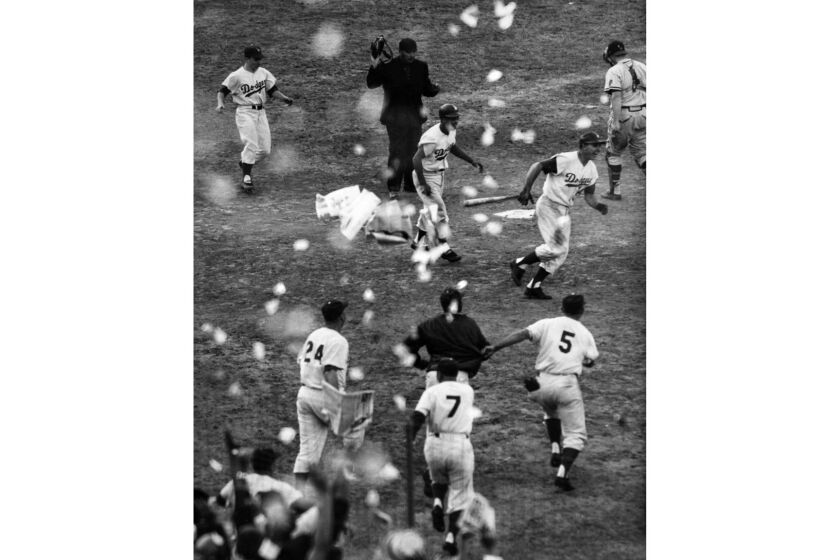 The Los Angeles Dodgers celebrate as they win the National League pennant in a game against the Milwaukee Braves on Sept. 30, 1959. (For 125 anniversary sports section)