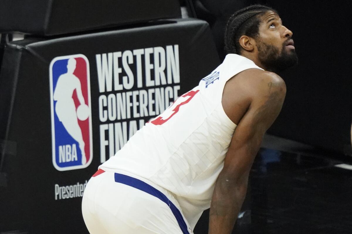 Clippers forward Paul George catches his breath during a break in the action.