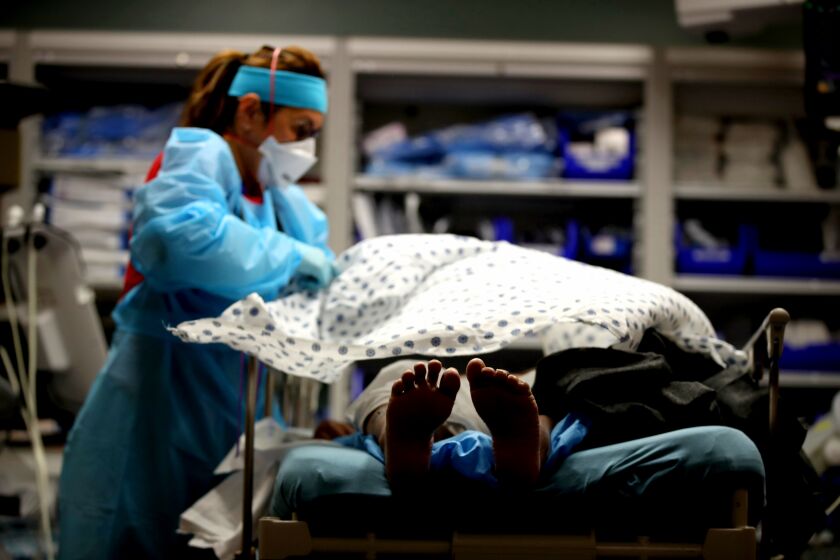 SAN JOSE, CALIFORNIA - MAY 21: (EDITORIAL USE ONLY) A nurse places a blanket over a patient that had just been admitted to the emergency room at Regional Medical Center on May 21, 2020 in San Jose, California. Frontline workers are continuing to care for coronavirus COVID-19 patients throughout the San Francisco Bay Area. Santa Clara county, where this hospital is located, has had the most deaths of any Northern California county, and the earliest known COVID-19 related deaths in the United States. (Photo by Justin Sullivan/Getty Images)
