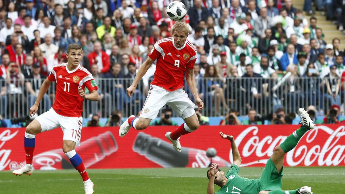 Russia's Yuri Gazinsky heads the ball to score the opening goal during a match against Saudi Arabia to open the 2018 World Cup on June 14.