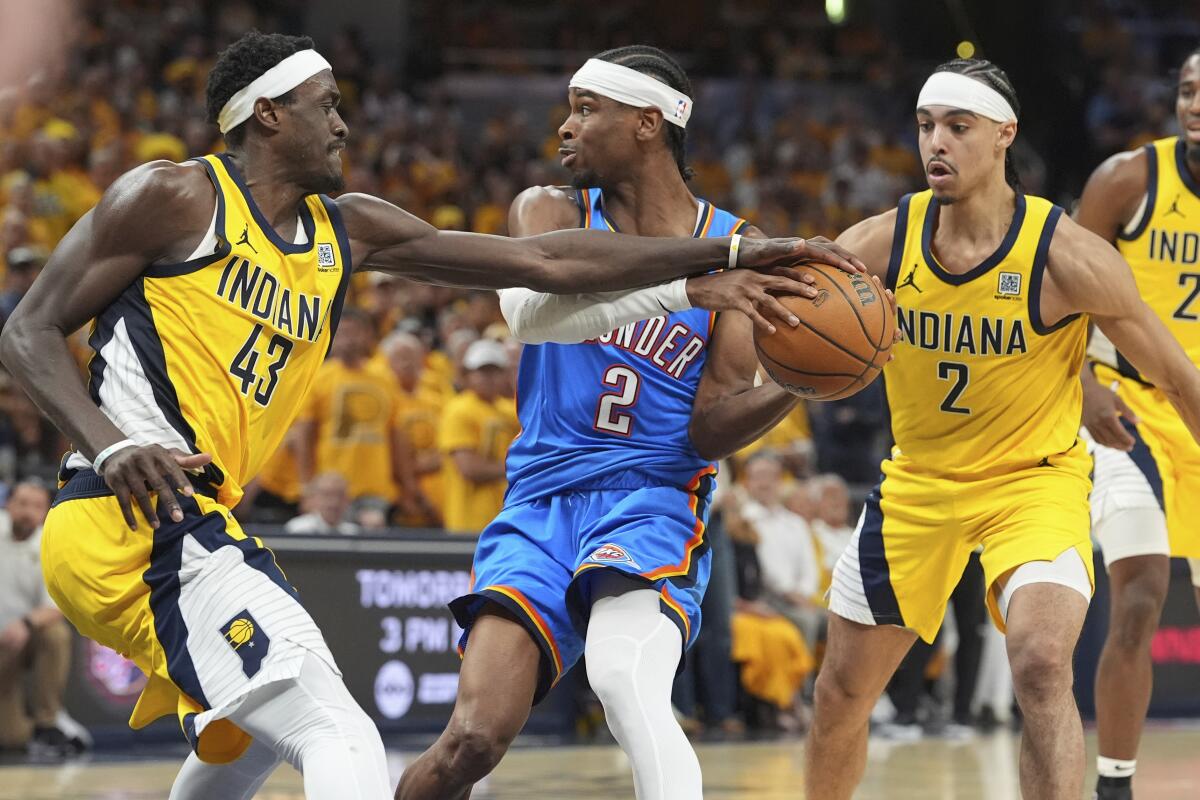 Oklahoma City Thunder guard Shai Gilgeous-Alexander (2) is pressured by Indiana Pacers.