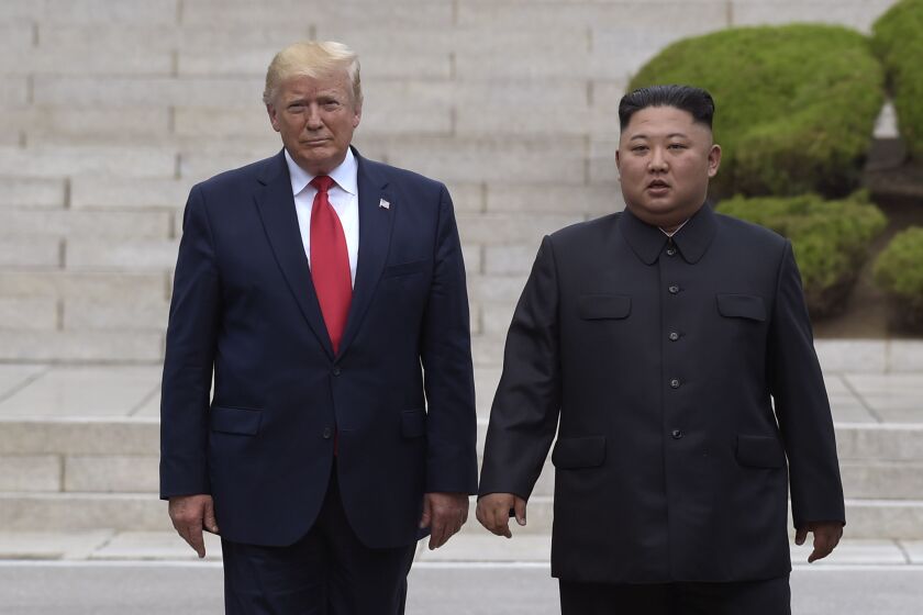 FILE- In this June 30, 2019 file photo, President Donald Trump, left, meets with North Korean leader Kim Jong Un at the North Korean side of the border at the village of Panmunjom in Demilitarized Zone. North Korea on Sunday dismissed as “ungrounded” President Donald Trump’s comment that he recently received “a nice note” from the North's leader, Kim Jong Un. (AP Photo/Susan Walsh, File)