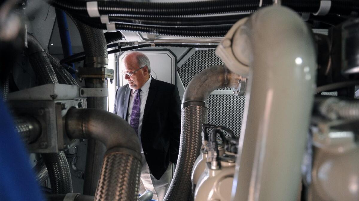 Rick Tripoli, Metrolink's director of equipment, walks through one of 40 new engines the commuter rail line is buying.