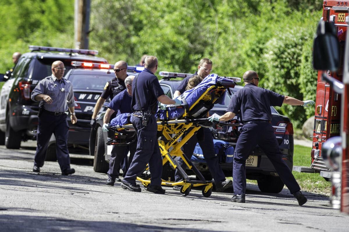 Rescue workers take 12-year-old stabbing victim Payton Leutner to an ambulance in Waukesha, Wis., in May 2014.