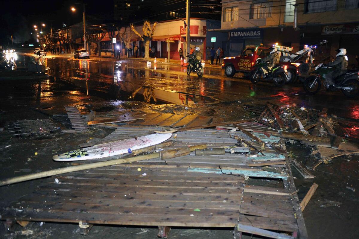 Police patrol a debris-strewn street in Valparaiso, Chile, after a tsunami hit the area following a massive earthquake on Sept. 16.