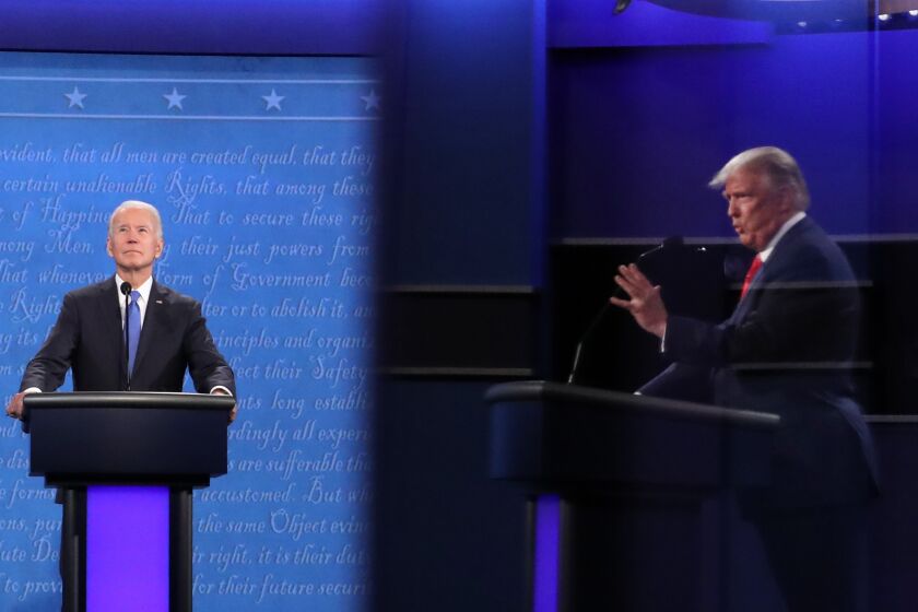 NASHVILLE, TENNESSEE - OCTOBER 22: U.S. President Donald Trump (shown in reflection) and Democratic presidential nominee Joe Biden participate in the final presidential debate at Belmont University on October 22, 2020 in Nashville, Tennessee. This is the last debate between the two candidates before the election on November 3. (Photo by Chip Somodevilla/Getty Images)