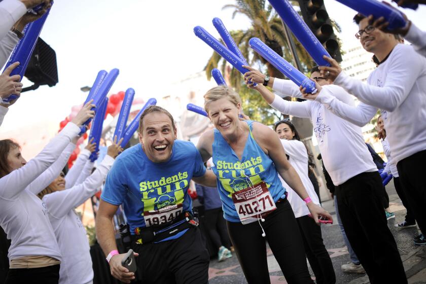 Sanjin and Sarah Gacina of Los Angeles celebrate renewing their wedding vows at mile 10 of the L.A. Marathon.