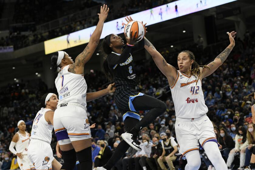 The Sky's Kahleah Copper goes up for a shot against the Mercury's Brittney Griner (42) and Kia Vaughn (1) on Oct. 15, 2021.