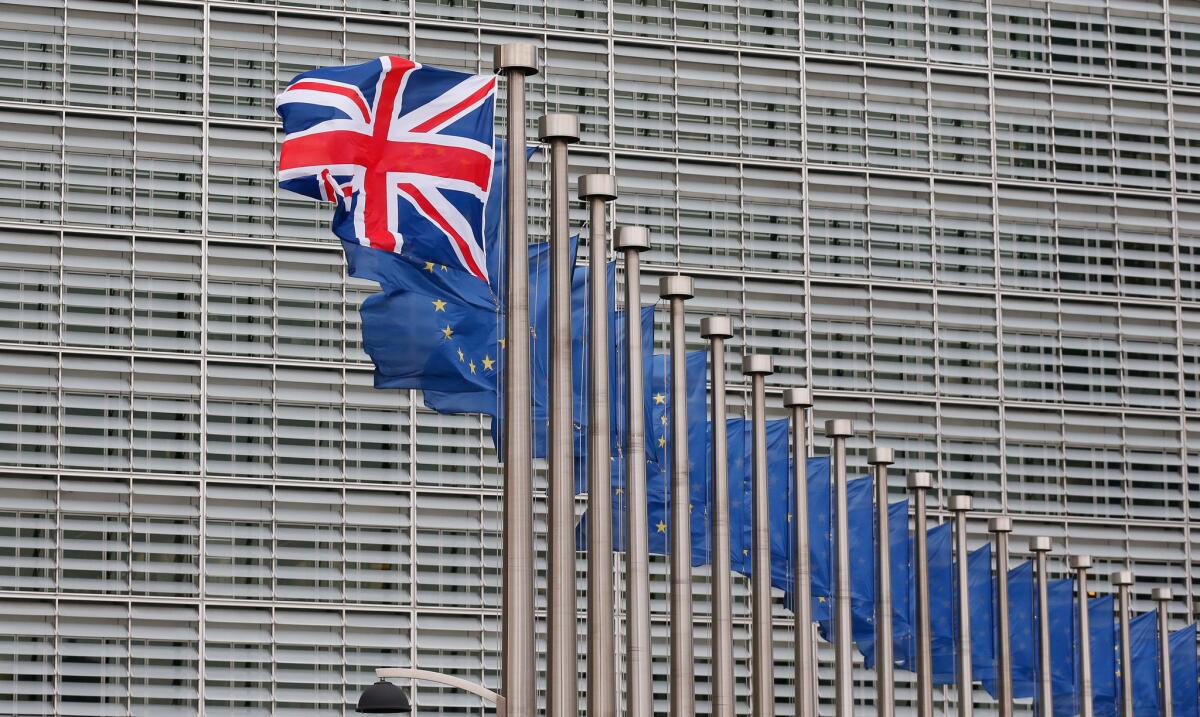 The British Union Jack flutters next to European Union flags at the European Commission in Brussels, Belgium.