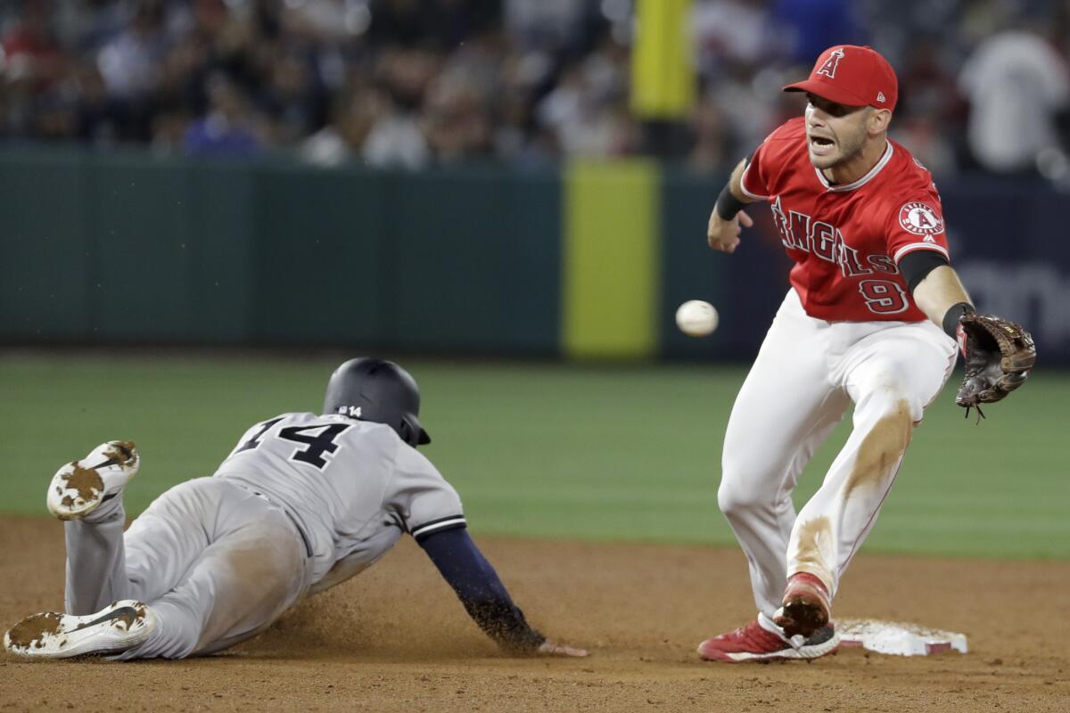New York Yankees' Tyler Wade, left, steals second past Angels second baseman Tommy La Stella during the ninth inning on Tuesday at Angel Stadium.