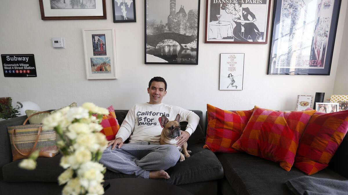 Conrad Ricamora relaxes with his French bulldog, Wilbur, before rehearsal for the Ahmanson's production of David Henry Hwang's "Soft Power."