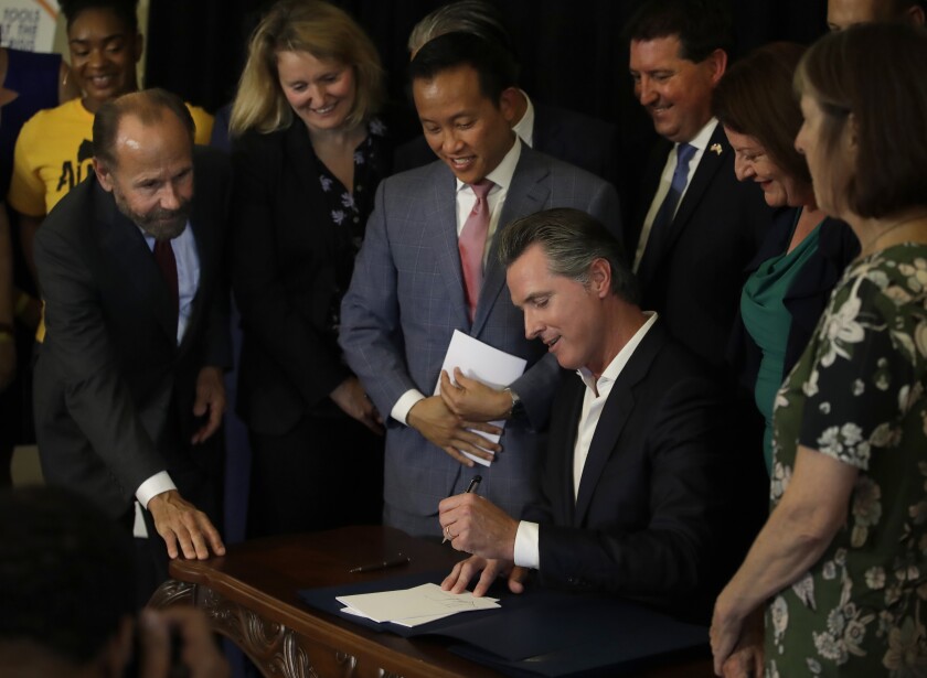 California Gov. Gavin Newsom signs bill AB 1482 on Oct. 8 in Oakland. AB 1482 will cap rent increases at 5 percent each year plus inflation. The bill will also ban landlords from evicting tenants without just cause.