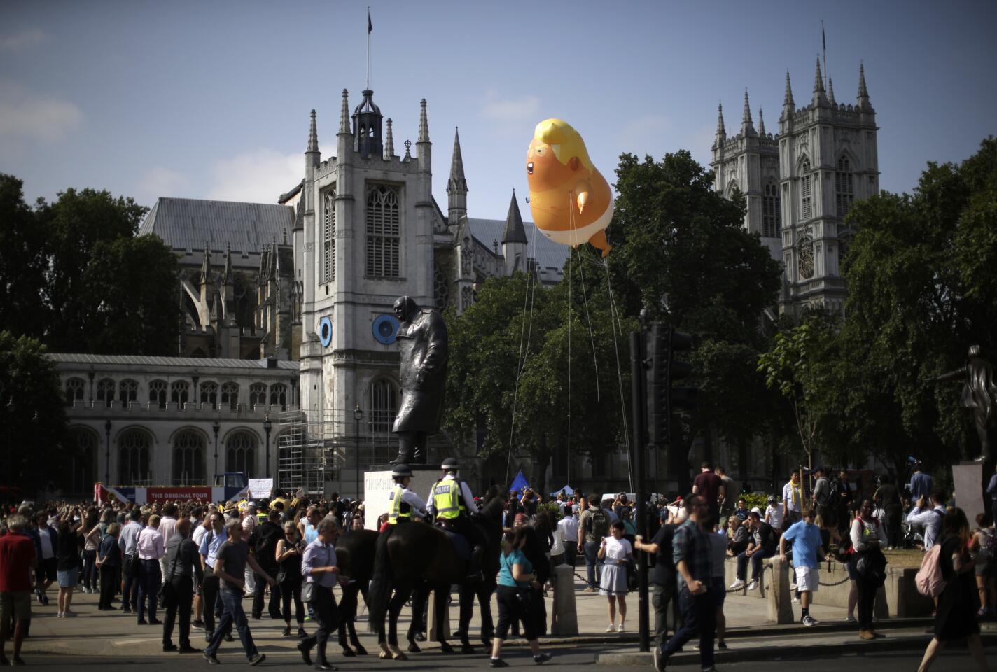 A 20-foot tall balloon depicting U.S. President Donald Trump as a screaming baby hovers next to the statue of former British Prime Minister Winston Churchill in Parliament Square in London.