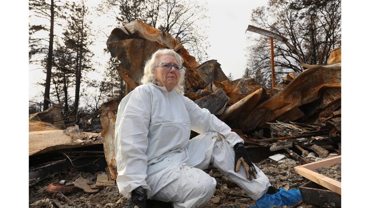 Ann Rahlf sifts through the remains of her home in Paradise. She is grateful that her husband, David, made it out alive.