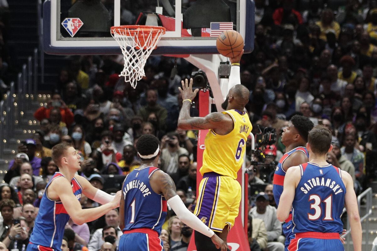 The Lakers' LeBron James scores against the Washington Wizards on March 19, 2022.