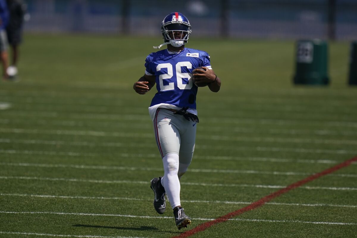 New York Giants' Saquon Barkley participates in a practice at the NFL football team's training facility in East Rutherford, N.J., Wednesday, June 8, 2022. (AP Photo/Seth Wenig)