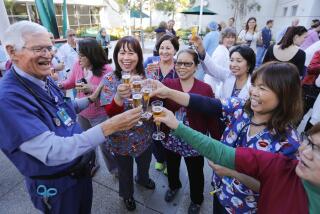 CHULA VISTA, CA 12/19/2017: Melvin Ochs, M.D., left, who retired after a storied career, nearly 50-years of that in the emergency department at Scripps Mercy Hospital Chula Vista where he was the director of the emergency department is toasted with glasses of apple cider by emergency department nurses and staff during a small gathering at the hospital. Staff photo by Howard Lipin/The San Diego Union-Tribune/ZUMA Press Copyright 2017 The San Diego Union-Tribune