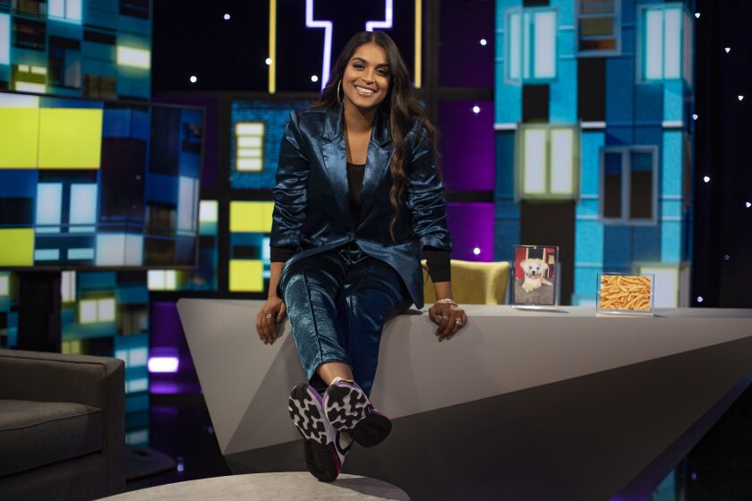 LOS ANGELES, CA - SEPTEMBER 9, 2019: Sitting next to two of her favorite things, her dog and French fries, Lilly Singh is on the set of her new talk show "A Little Late with Lilly Singh" on September 9, 2019 in Los Angeles, California. (Gina Ferazzi/Los AngelesTimes)