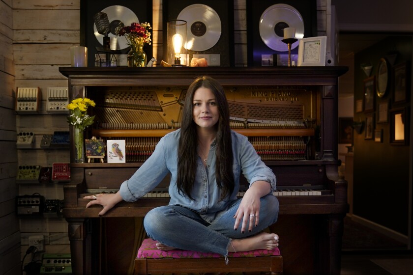 Gena Johnson poses in her home studio in Nashville, Tenn. on April 8, 2021. Johnson, a recording engineer, is the first woman to ever be nominated for engineer of the year by the Academy of Country Music. (AP Photo/Mark Humphrey)