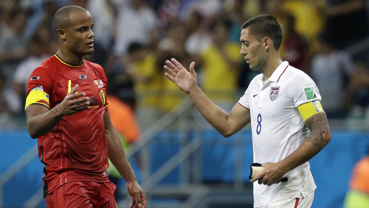 Belgium's Vincent Kompany, left, is congratulated by U.S. forward Clint Dempsey after the USA's 2-1 loss in the World Cup on Tuesday. The U.S. struggled with fatigue during the second half of the match.