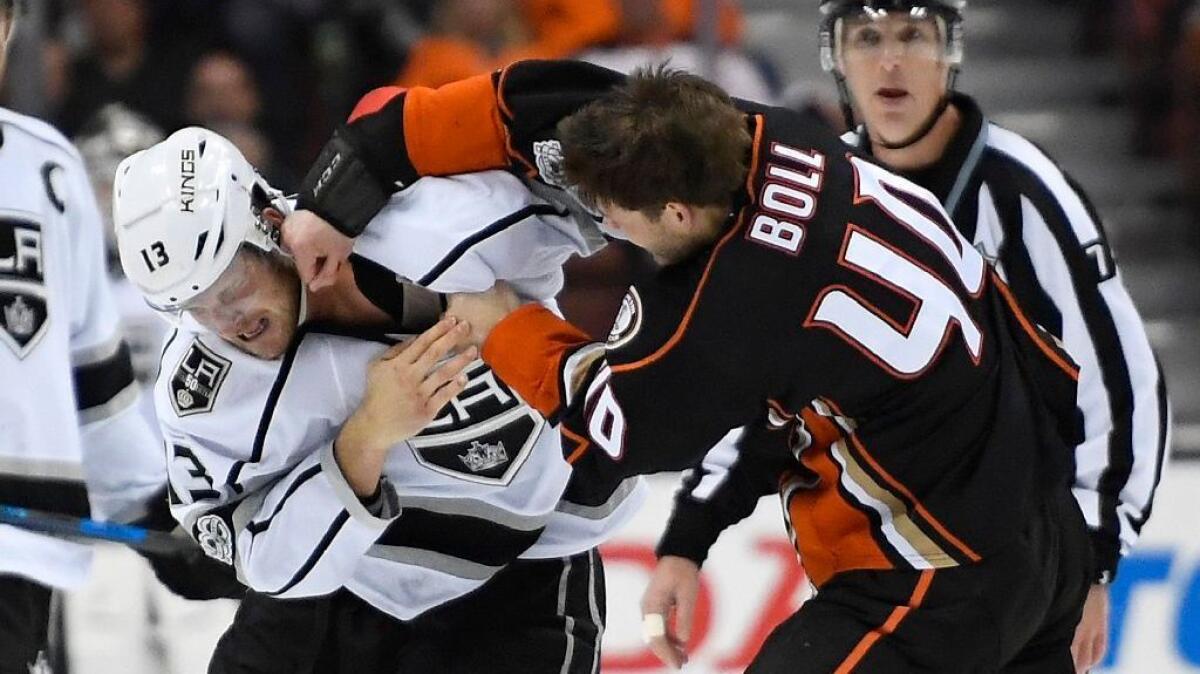 Kings left wing Kyle Clifford, left, and Anaheim Ducks right wing Jared Boll fight during the first period of a game on Feb. 19.