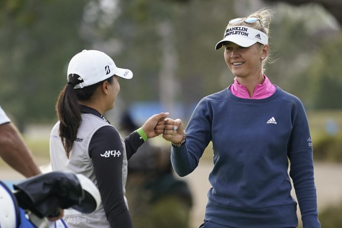 Jessica Korda, right, and Jin Young Ko bump fists at the end the third round in the HUGEL Air Premia LA Open.