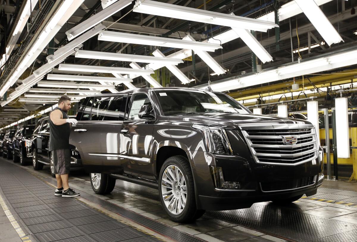 Efren Martin II inspects a Cadillac Escalade as it nears the final process of assembly at the General Motors plant in Arlington, Texas.