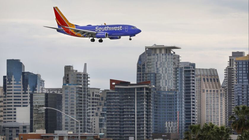 A Southwest Airlines Boeing 737 passes in front of the downtown San Diego skyline moments before landing at San Diego International Airport.