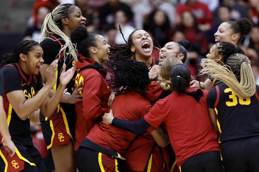 Southern California celebrates a win after an NCAA college basketball game against Stanford.